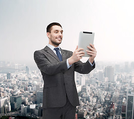 Image showing smiling buisnessman with tablet pc computer