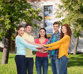 Image showing group of smiling teenagers over campus background