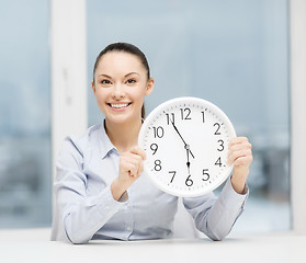 Image showing attractive businesswoman with white clock