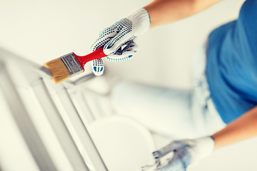 Image showing woman with paintbrush and paint pot