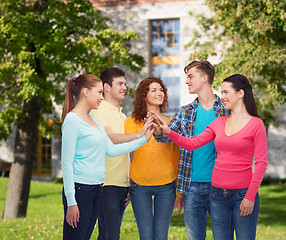 Image showing group of smiling teenagers over campus background