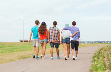 Image showing group of teenagers walking outdoors from back
