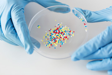 Image showing close up of scientist hands holding chemical cure