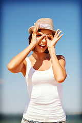 Image showing girl making funny faces on the beach