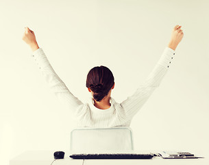 Image showing woman from the back with raised hands