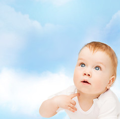 Image showing curious baby looking up