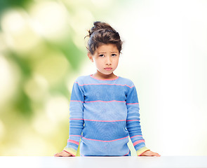 Image showing sad little girl over city background