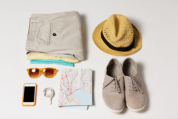 Image showing close up of summer clothes and travel map on table