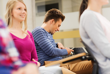 Image showing group of smiling students in lecture hall