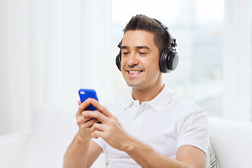 Image showing happy man with smartphone and headphones