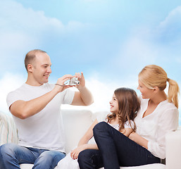 Image showing happy family with camera at home