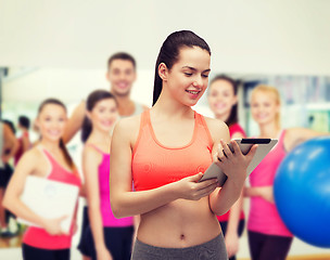 Image showing sporty woman with tablet pc computer