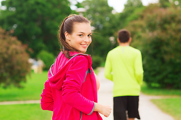 Image showing smiling couple running outdoors