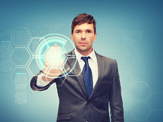 Image showing attractive buisnessman working with virtual screen