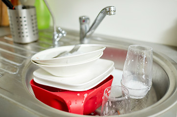 Image showing close up of dirty dishes washing in kitchen sink