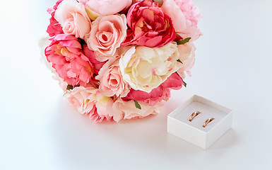 Image showing close up of gay wedding rings and flower bunch