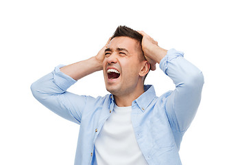 Image showing unhappy man with closed eyes touching his forehead