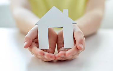 Image showing close up of happy girl hands holding paper house