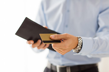 Image showing close up of man holding wallet and credit card