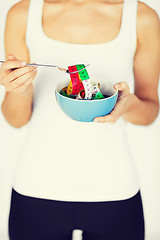 Image showing woman hands holding bowl with measuring tape