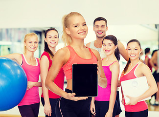 Image showing smiling woman showing tablet pc blank screen