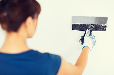 Image showing woman plastering the wall with trowel