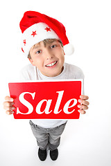 Image showing Standing boy holding sale sign