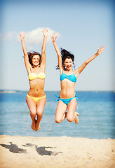 Image showing girls jumping on the beach