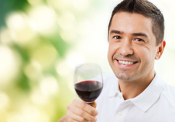 Image showing happy man drinking red wine from glass