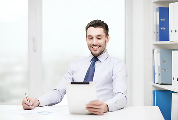 Image showing smiling businessman with tablet pc and documents