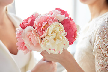 Image showing close up of happy lesbian couple with flowers