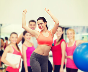 Image showing smiling teenage girl in sportswear dancing