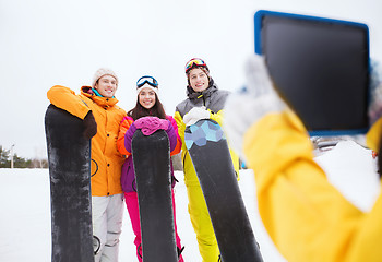 Image showing happy friends with snowboards and tablet pc