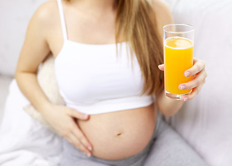 Image showing close up of happy pregnant woman with orange juice