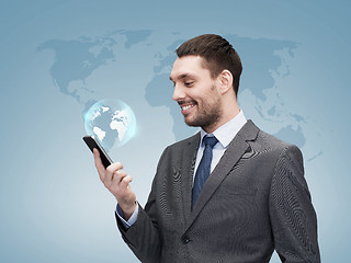 Image showing young smiling businessman with smartphone