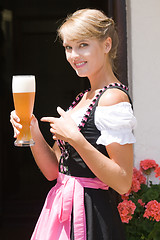 Image showing Young woman in dirndl with white beer