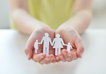 Image showing close up of child hands with paper family cutout