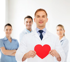 Image showing smiling male doctor with red heart