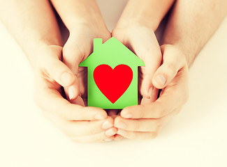 Image showing couple hands holding green paper house