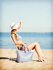 Image showing girl sunbathing on the beach chair