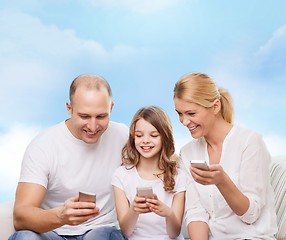 Image showing happy family with smartphones