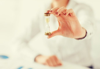 Image showing woman hand with sandglass