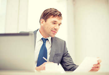 Image showing businessman with laptop computer and documents