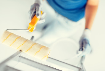 Image showing woman with roller and paint pot