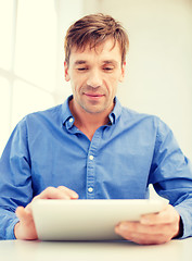 Image showing man working with tablet pc at home