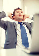 Image showing relaxed businessman with laptop in office