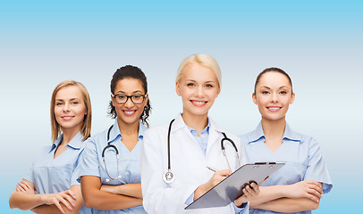 Image showing smiling female doctor and nurses with stethoscope