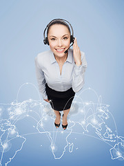 Image showing friendly female helpline operator with headphones