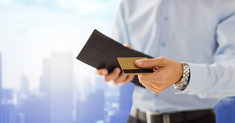 Image showing close up of man holding wallet and credit card