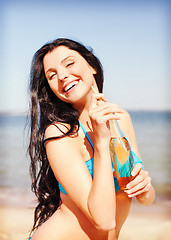 Image showing girl with bottle of drink on the beach